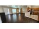 Open concept living room and kitchen with dark floors at 4530 Irdell Ter, North Port, FL 34288