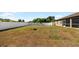 Large backyard with fenced enclosure, playset, and fire pit at 4530 Irdell Ter, North Port, FL 34288