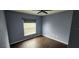 Spacious bedroom with dark wood-look floors and a light purple wall at 4530 Irdell Ter, North Port, FL 34288