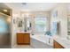 Elegant bathroom with corner bathtub, double sinks, and a walk-in shower at 4530 Irdell Ter, North Port, FL 34288