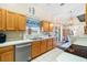 Kitchen featuring wood cabinets, updated appliances, and a view to the dining area at 4530 Irdell Ter, North Port, FL 34288