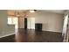 Open living room with dark wood-look floors and high ceilings at 4530 Irdell Ter, North Port, FL 34288