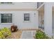 Exterior view of condo building, showing unit entrance with landscaping at 26485 Rampart Blvd # D3, Punta Gorda, FL 33983