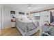 Cozy bedroom with a queen-size bed, barn door, and wood floors at 26485 Rampart Blvd # D3, Punta Gorda, FL 33983