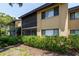 Charming two-story condo with a screened porch and well-maintained landscaping including vibrant flowering bushes at 5685 Ashton Lake Dr # 2, Sarasota, FL 34231