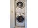 Efficient laundry closet featuring a stacked washer and dryer for space-saving convenience at 5685 Ashton Lake Dr # 2, Sarasota, FL 34231