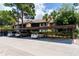 Assigned covered parking spots at condo with mature landscaping and palm trees surrounding the area at 5685 Ashton Lake Dr # 2, Sarasota, FL 34231