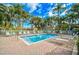 Relaxing pool with lounge chairs and palm trees for a tropical vacation vibe at 5685 Ashton Lake Dr # 2, Sarasota, FL 34231
