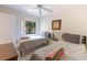 Bright bedroom with twin beds, ceiling fan, and window at 5685 Ashton Lake Dr # 2, Sarasota, FL 34231