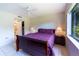 Bedroom with double bed, ceiling fan, and access to bathroom at 5685 Ashton Lake Dr # 2, Sarasota, FL 34231