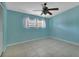 Simple bedroom with light blue walls and tile flooring at 3365 Westlund Ter, Port Charlotte, FL 33952