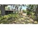 Spacious backyard featuring a home with a screened porch and lush landscaping at 18300 Troon Ave, Port Charlotte, FL 33948