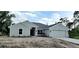 Newly built home with gray exterior and landscaping at 18321 Eblis Ave, Port Charlotte, FL 33948
