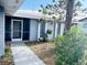 Front entrance with walkway leading to the screened entry at 75 Annapolis Ln, Rotonda West, FL 33947
