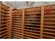 Spacious wine cellar with ample wooden shelving for extensive wine storage at 1060 San Mateo Dr, Punta Gorda, FL 33950