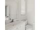 Simple, clean bathroom with white vanity and toilet at 1060 San Mateo Dr, Punta Gorda, FL 33950
