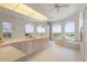 Large Primary bathroom with dual sinks, a soaking tub, and lots of natural light at 1060 San Mateo Dr, Punta Gorda, FL 33950