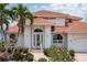 Two-story house with tile roof, palm trees, and landscaped gardens at 1060 San Mateo Dr, Punta Gorda, FL 33950