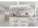 White kitchen with breakfast bar and views into Gathering room at 1060 San Mateo Dr, Punta Gorda, FL 33950