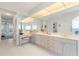 Primary bathroom with dual sinks, vanity, and a view into the bedroom at 1060 San Mateo Dr, Punta Gorda, FL 33950