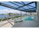 Inviting pool and spa with a covered patio and waterfront views at 1060 San Mateo Dr, Punta Gorda, FL 33950