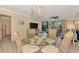 Bright dining area with glass table and wicker chairs, offering views to living room at 8750 Midnight Pass Rd # 202, Sarasota, FL 34242
