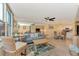 Bright living room with light blue sofa, wood coffee table, and adjacent dining area at 8750 Midnight Pass Rd # 202, Sarasota, FL 34242