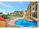 Community pool with lounge chairs and patio tables at 8750 Midnight Pass Rd # 202, Sarasota, FL 34242
