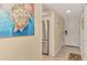 Bright entryway with tile flooring, a stainless steel refrigerator, and coastal-themed art at 8750 Midnight Pass Rd # 202, Sarasota, FL 34242