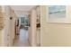 Long hallway leading to living areas with tile flooring and coastal decor at 8750 Midnight Pass Rd # 202, Sarasota, FL 34242