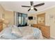 Bright bedroom with a comfortable bed and dresser, plus a balcony view at 8750 Midnight Pass Rd # 202, Sarasota, FL 34242