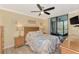 Comfortable bedroom with ceiling fan, wood furniture, and beachy decor at 8750 Midnight Pass Rd # 202, Sarasota, FL 34242