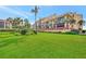 Building exterior with lush landscaping and ocean view at 8750 Midnight Pass Rd # 202, Sarasota, FL 34242