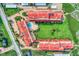 Aerial view of a community with lush landscaping, pool, and red tile roofs at 8750 Midnight Pass Rd # 202, Sarasota, FL 34242