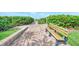 Brick pathway to the beach with benches at 8750 Midnight Pass Rd # 202, Sarasota, FL 34242