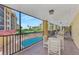 Covered lanai with outdoor seating overlooking pool at 8750 Midnight Pass Rd # 202, Sarasota, FL 34242