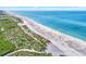 Aerial view of beach, shoreline and dune vegetation at 8750 Midnight Pass Rd # 202, Sarasota, FL 34242