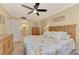 Main bedroom with a dresser, ceiling fan, and beachy bedding at 8750 Midnight Pass Rd # 202, Sarasota, FL 34242