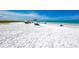 Relaxing beach scene with people under umbrellas and clear water at 8750 Midnight Pass Rd # 202, Sarasota, FL 34242