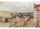 Community room with tables, chairs, and a bookcase at 8750 Midnight Pass Rd # 202, Sarasota, FL 34242