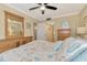 Serene bedroom with dresser, ceiling fan, and access to bathroom at 8750 Midnight Pass Rd # 202, Sarasota, FL 34242