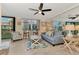 Relaxing living room with blue sofa, ceiling fan, and coastal decor at 8750 Midnight Pass Rd # 202, Sarasota, FL 34242