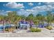 Beach playground with picnic tables and palm trees surrounding at 8750 Midnight Pass Rd # 202, Sarasota, FL 34242