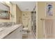 Updated bathroom with granite countertop, white cabinets, and walk-in shower at 8750 Midnight Pass Rd # 202, Sarasota, FL 34242