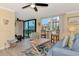 Spacious living room with blue sofa and coastal decor, open to dining and kitchen at 8750 Midnight Pass Rd # 202, Sarasota, FL 34242