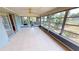 Spacious screened porch with tiled floors and backyard access at 18300 Troon Ave, Port Charlotte, FL 33948