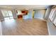 Open concept living and kitchen area with light wood flooring at 18300 Troon Ave, Port Charlotte, FL 33948