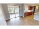 Bright dining area with wood-look floors and sliding glass doors to patio at 18300 Troon Ave, Port Charlotte, FL 33948