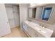 Double vanity bathroom with marble countertop and storage at 18300 Troon Ave, Port Charlotte, FL 33948