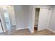 Hallway with wood-look floors and built-in storage at 18300 Troon Ave, Port Charlotte, FL 33948